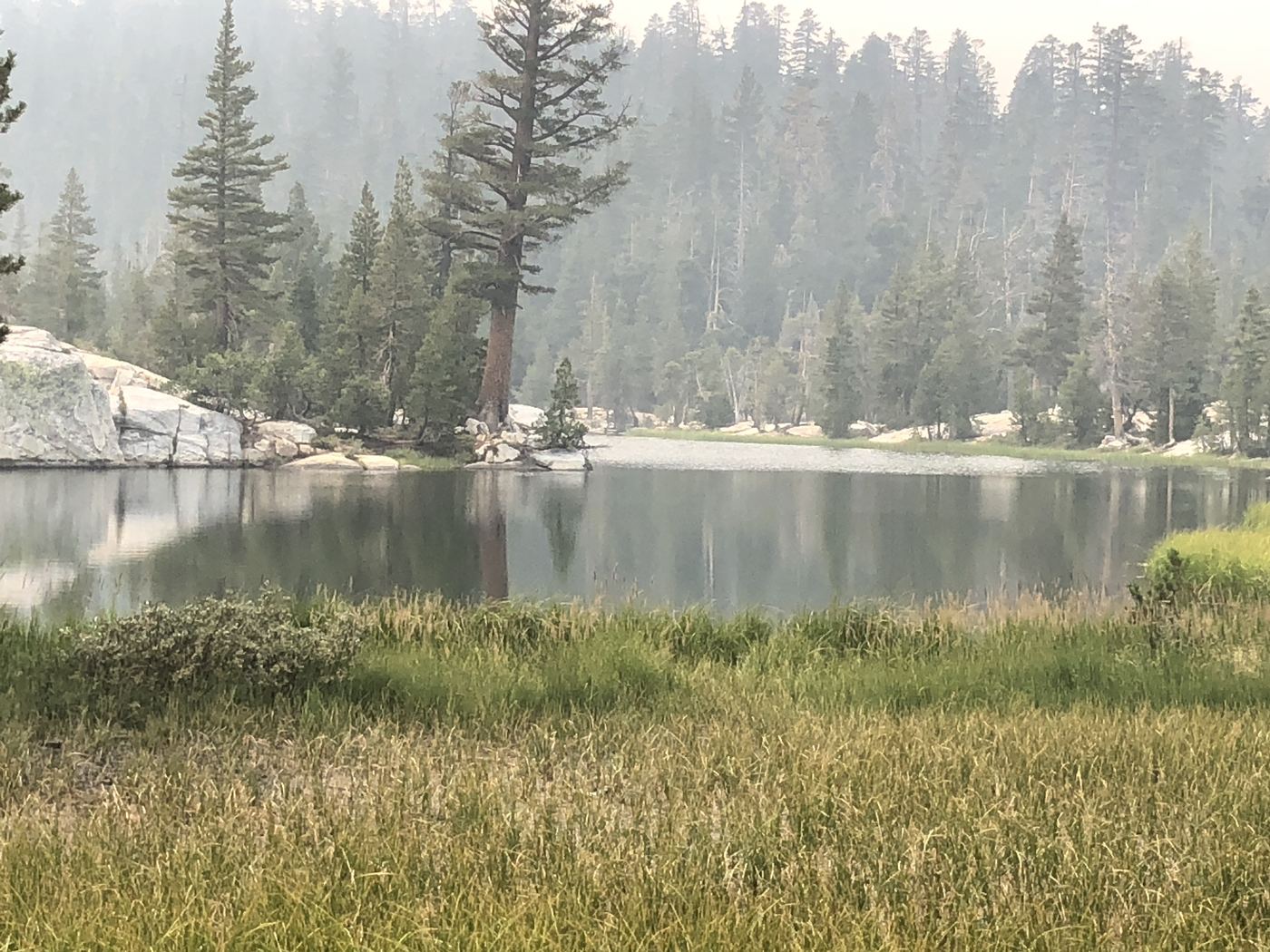 The view across Middle Velma Lake obscured by wildfire smoke haze