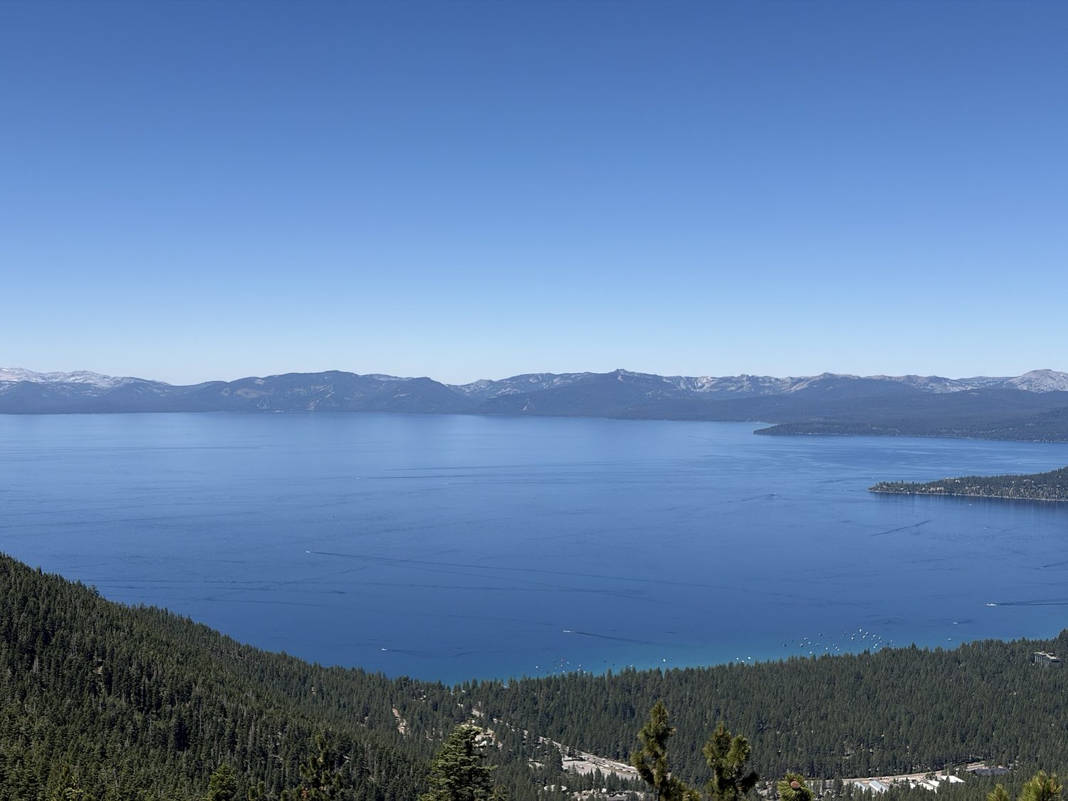 Deep blue Lake Tahoe filling the view from a high forested overlook above Marlette on the east rim