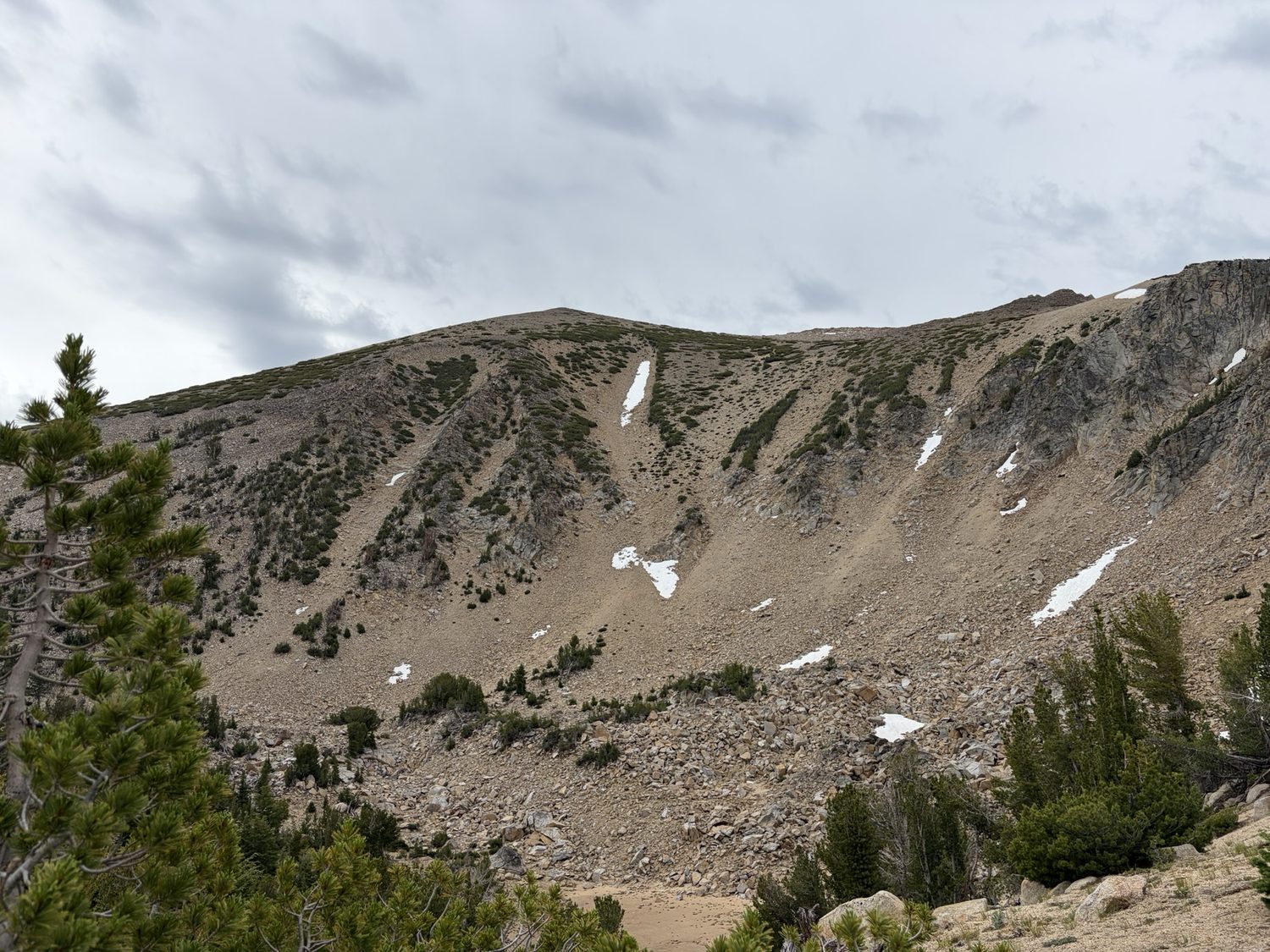 The Freel Peak massif with lingering snow patches under building clouds