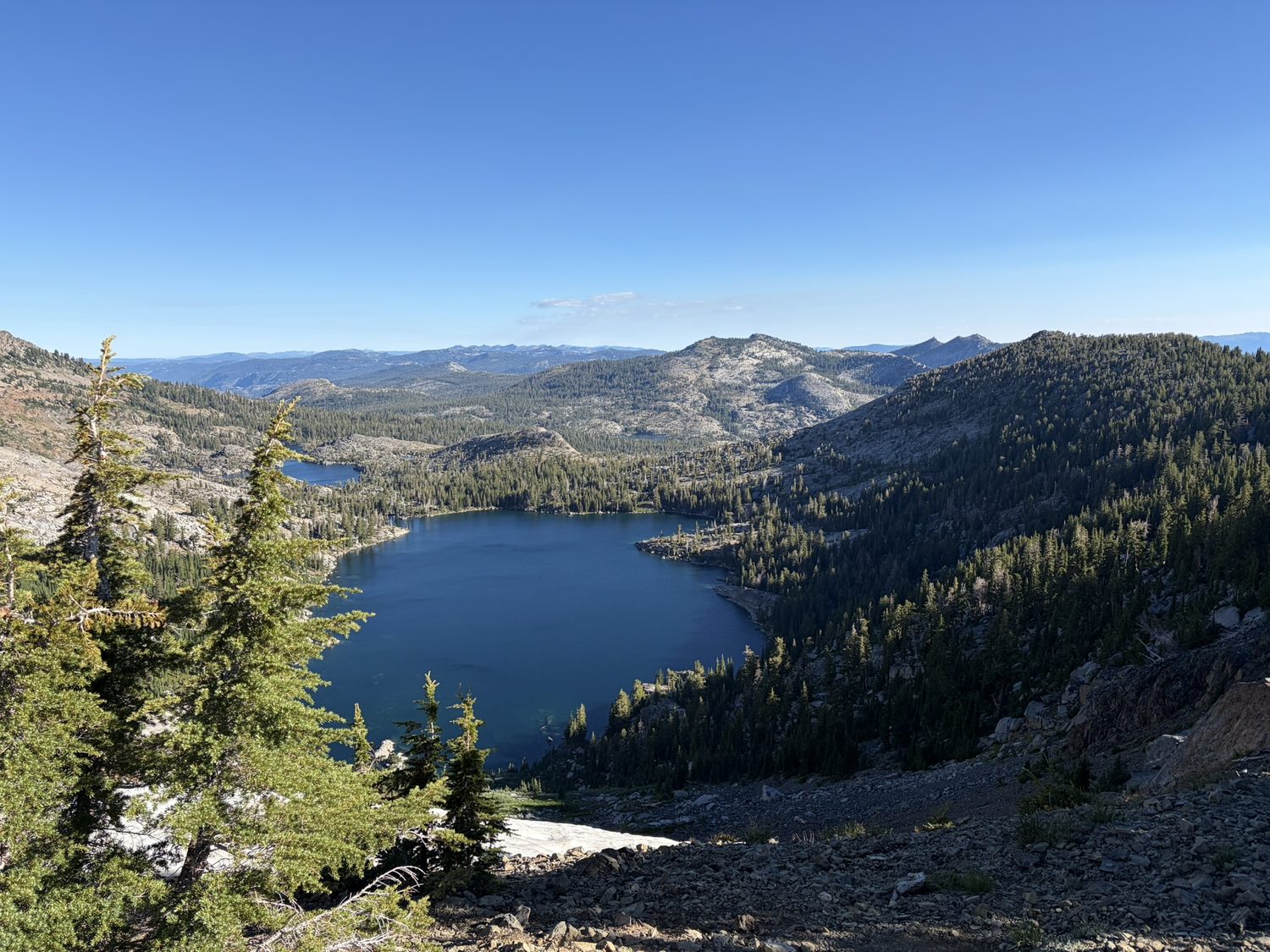 A deep blue alpine lake seen from above, ringed by granite in Desolation Wilderness