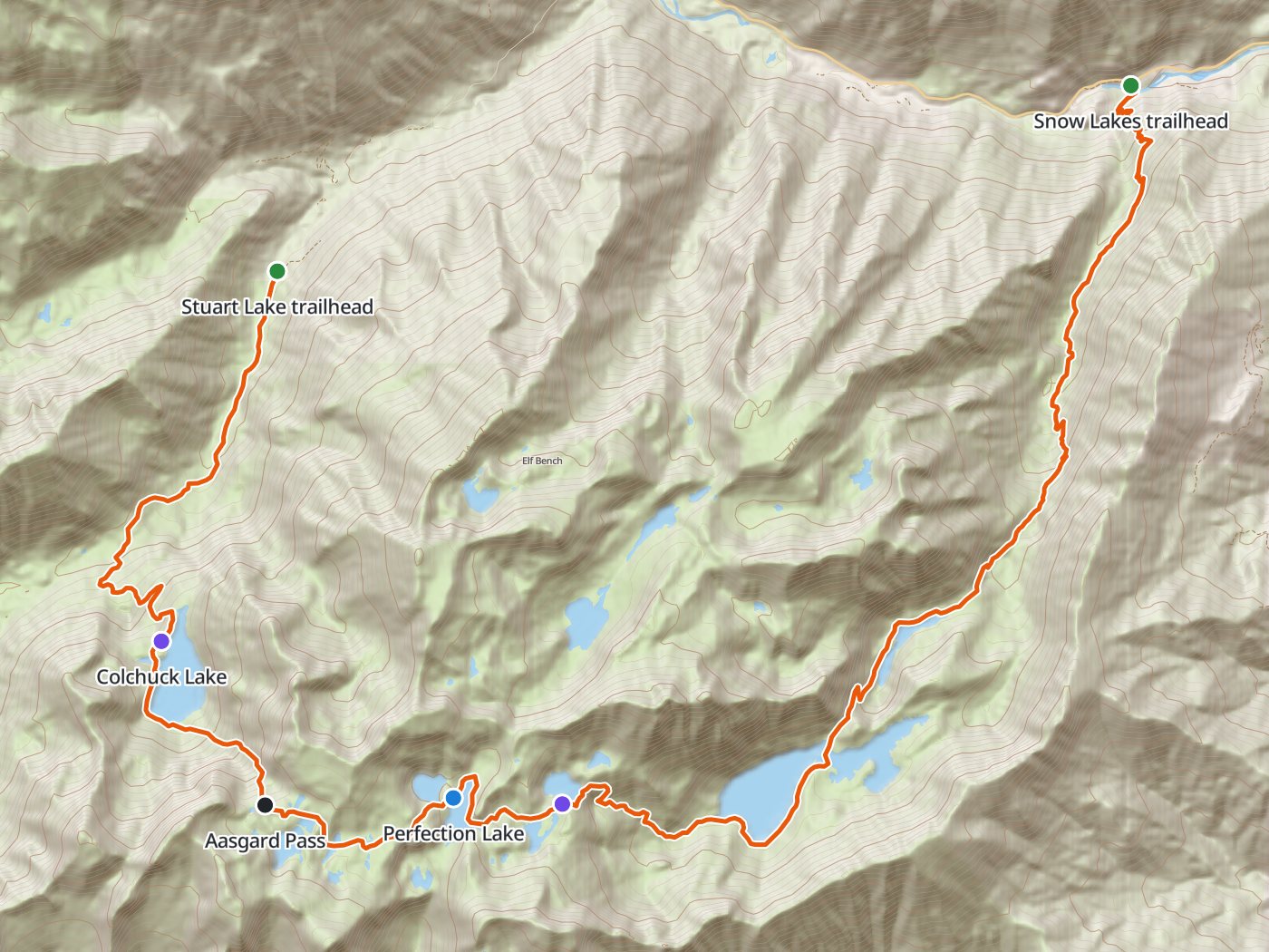 Topographic map of the Enchantments through-hike, with the route drawn in orange from the Stuart Lake trailhead south to Colchuck Lake, east over Aasgard Pass past Perfection Lake through the Core Enchantments, and northeast past the Snow Lakes to the Snow Lakes trailhead
